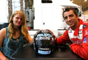 Janelle Sowders, the helmet she designed with the theme “never give up,” and Justin Wilson in 2012.